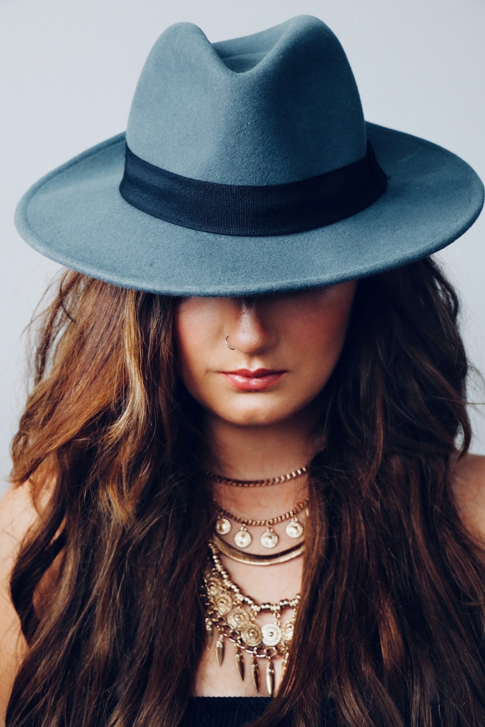 Woman wearing artisan felt hat with feather